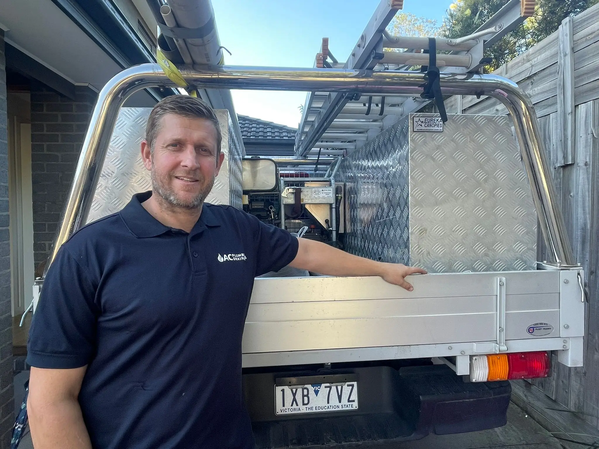 Allan Cameron of AC Plumbing and Drainage beside the branded work ute in Preston.